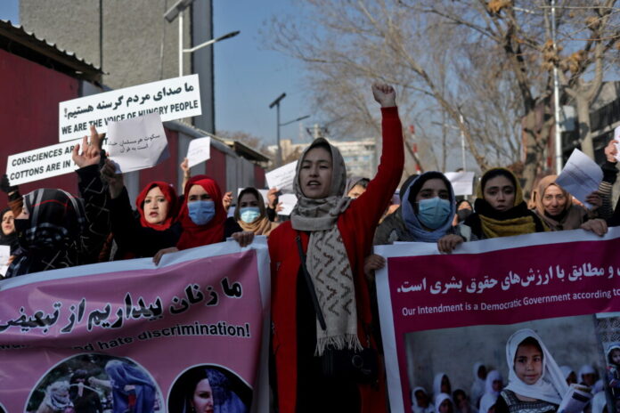 Afghan women shout slogans during a rally to protest against what the protesters say is Taliban restrictions on women, in Kabul
